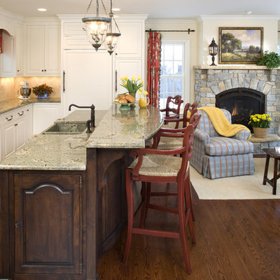 Example of a mountain style l-shaped open concept kitchen design in Minneapolis with an integrated sink, raised-panel cabinets, white cabinets, beige backsplash and paneled appliances