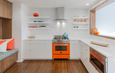 Eye-Popping Orange Range Warms Up a Sleek White Kitchen