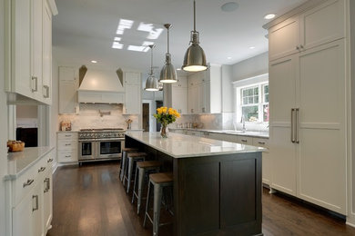 Example of a large classic dark wood floor kitchen design in Minneapolis with an undermount sink, white cabinets, marble countertops, white backsplash and paneled appliances