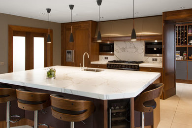 Inspiration for a large contemporary kitchen/diner in Edinburgh with brown cabinets, marble splashback and an island.