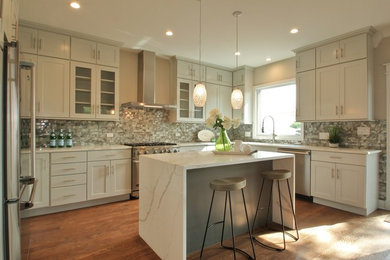 Eat-in kitchen - mid-sized transitional u-shaped dark wood floor and brown floor eat-in kitchen idea in Chicago with an island, an undermount sink, recessed-panel cabinets, gray cabinets, quartzite countertops, metallic backsplash, ceramic backsplash, stainless steel appliances and white countertops