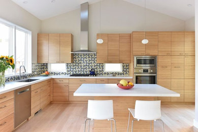 Eat-in kitchen - large contemporary l-shaped light wood floor eat-in kitchen idea in San Francisco with an undermount sink, flat-panel cabinets, stainless steel appliances, an island, medium tone wood cabinets, quartzite countertops, multicolored backsplash and ceramic backsplash