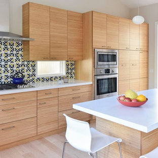 Large contemporary eat-in kitchen pictures - Example of a large trendy l-shaped light wood floor eat-in kitchen design in San Francisco with an undermount sink, flat-panel cabinets, medium tone wood cabinets, quartzite countertops, multicolored backsplash, ceramic backsplash, stainless steel appliances and an island
