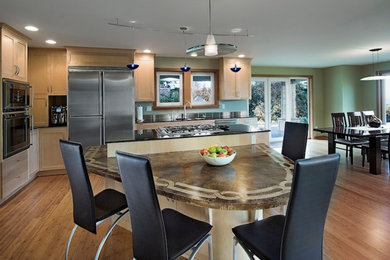 Mid-sized transitional l-shaped light wood floor eat-in kitchen photo in Seattle with an undermount sink, shaker cabinets, light wood cabinets, quartz countertops, blue backsplash, stainless steel appliances and an island