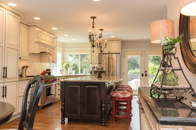 Inspiration for a large transitional l-shaped medium tone wood floor eat-in kitchen remodel in Seattle with an undermount sink, raised-panel cabinets, white cabinets, granite countertops, white backsplash, ceramic backsplash, stainless steel appliances and an island