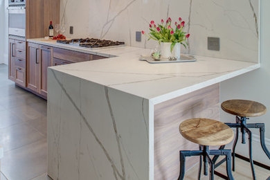 Large trendy l-shaped ceramic tile and gray floor eat-in kitchen photo in San Francisco with an undermount sink, shaker cabinets, medium tone wood cabinets, quartz countertops, white backsplash, stainless steel appliances and white countertops