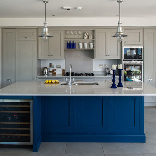 Design ideas for a large transitional galley open plan kitchen in Dublin with an integrated sink, recessed-panel cabinets, grey cabinets, quartz benchtops, grey splashback, porcelain floors and with island.