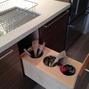 This is an example of a large midcentury galley open plan kitchen in San Francisco with an undermount sink, flat-panel cabinets, medium wood cabinets, quartz benchtops, white splashback, stone slab splashback, stainless steel appliances, light hardwood floors, a peninsula and beige floor.