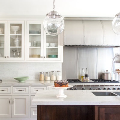 Eat-in kitchen - mid-sized traditional l-shaped medium tone wood floor eat-in kitchen idea in Los Angeles with an undermount sink, beaded inset cabinets, white cabinets, white backsplash, stainless steel appliances, an island, marble countertops and stone tile backsplash