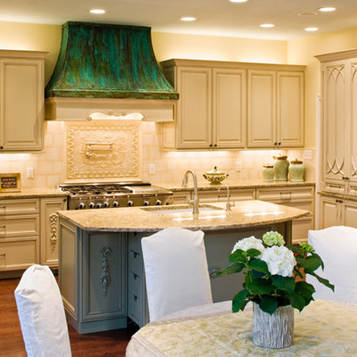 Inspiration for a timeless eat-in kitchen remodel in Austin with an undermount sink, raised-panel cabinets, beige cabinets, granite countertops and beige backsplash