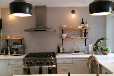 Transitional u-shaped kitchen photo in Calgary with quartzite countertops, gray backsplash, ceramic backsplash and stainless steel appliances