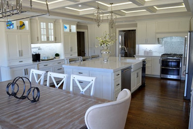 Inspiration for a large contemporary u-shaped medium tone wood floor and brown floor eat-in kitchen remodel in Little Rock with a farmhouse sink, shaker cabinets, white cabinets, quartz countertops, stainless steel appliances, an island, white backsplash, marble backsplash and white countertops