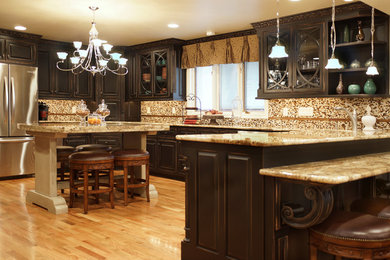 Inspiration for a large timeless l-shaped light wood floor and beige floor eat-in kitchen remodel in St Louis with an undermount sink, raised-panel cabinets, dark wood cabinets, granite countertops, multicolored backsplash, mosaic tile backsplash, stainless steel appliances and an island