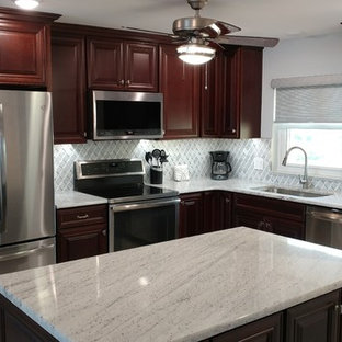 Mid-sized traditional open concept kitchen designs - Open concept kitchen - mid-sized traditional l-shaped porcelain tile and gray floor open concept kitchen idea in Tampa with a single-bowl sink, raised-panel cabinets, dark wood cabinets, granite countertops, white backsplash, marble backsplash, stainless steel appliances, an island and white countertops