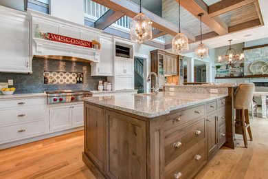 Inspiration for a huge transitional u-shaped light wood floor eat-in kitchen remodel in Milwaukee with a farmhouse sink, recessed-panel cabinets, white cabinets, quartz countertops, gray backsplash, ceramic backsplash, paneled appliances and an island