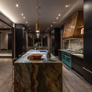 Inspiration for a large contemporary galley eat-in kitchen in Other with an undermount sink, flat-panel cabinets, black cabinets, granite benchtops, grey splashback, ceramic splashback, black appliances, ceramic floors, multiple islands, beige floor and grey benchtop.