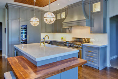 Transitional kitchen photo in Other with gray cabinets, an island and white countertops
