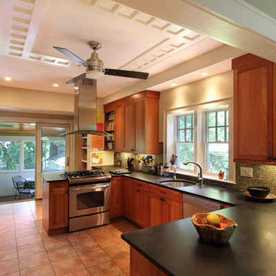 Arts and crafts u-shaped kitchen photo in DC Metro with stainless steel appliances, a single-bowl sink, recessed-panel cabinets, medium tone wood cabinets, multicolored backsplash and mosaic tile backsplash