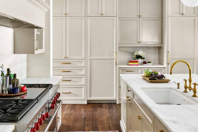 Kitchen - huge transitional medium tone wood floor and brown floor kitchen idea in Austin with an undermount sink, recessed-panel cabinets, gray cabinets, marble countertops, white backsplash, marble backsplash, stainless steel appliances, an island and white countertops