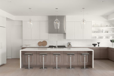 Inspiration for a modern u-shaped light wood floor and brown floor kitchen pantry remodel in San Francisco with an undermount sink, flat-panel cabinets, medium tone wood cabinets, marble countertops, white backsplash, marble backsplash, white appliances, an island and white countertops