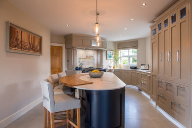 This is an example of a medium sized classic u-shaped kitchen/diner in Other with an integrated sink, shaker cabinets, grey cabinets, mosaic tiled splashback, coloured appliances, an island and grey floors.