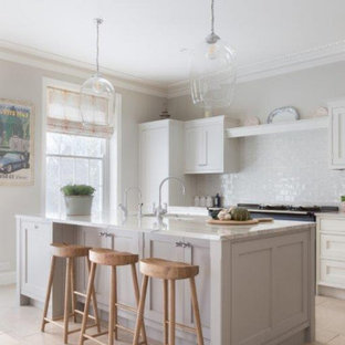 Inspiration for a large traditional kitchen in Hampshire with an integrated sink, shaker cabinets, grey cabinets, marble benchtops, porcelain splashback, coloured appliances, with island and white benchtop.