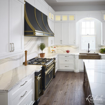 Elegant white kitchen graced with a copper farmhouse workstation sink
