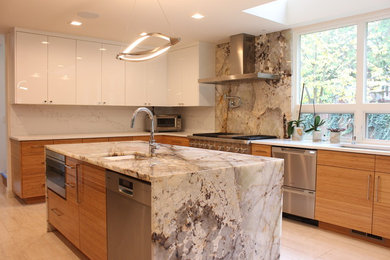 Inspiration for a large modern u-shaped porcelain tile and white floor kitchen pantry remodel in Seattle with an undermount sink, flat-panel cabinets, orange cabinets, granite countertops, white backsplash, stainless steel appliances, an island and beige countertops