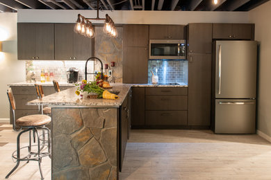 Example of a small urban galley laminate floor and beige floor open concept kitchen design in Baltimore with an undermount sink, flat-panel cabinets, brown cabinets, granite countertops, metallic backsplash, metal backsplash, stainless steel appliances, a peninsula and multicolored countertops