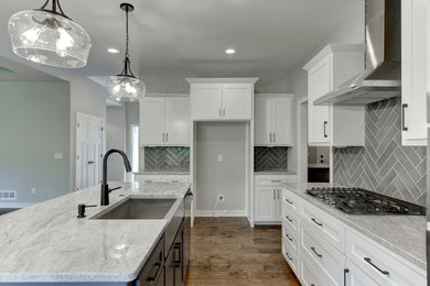 Inspiration for a transitional l-shaped eat-in kitchen remodel in Omaha with an island