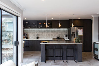 Inspiration for a medium sized grey and black kitchen/diner in Auckland with a built-in sink, dark wood cabinets, engineered stone countertops, ceramic splashback, stainless steel appliances, ceramic flooring, an island, grey floors and grey worktops.