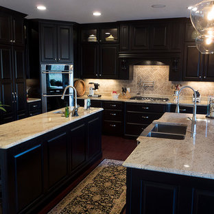 Aménagement d'une très grand cuisine américaine linéaire classique avec un évier de ferme, un placard avec porte à panneau surélevé, des portes de placard en bois sombre, un plan de travail en granite, une crédence beige, une crédence en carreau de céramique, un électroménager en acier inoxydable, un sol en bois foncé et 2 îlots.