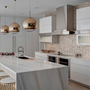 Eat-in kitchen - large contemporary l-shaped light wood floor eat-in kitchen idea in Chicago with an undermount sink, flat-panel cabinets, white cabinets, metallic backsplash, stainless steel appliances, an island, marble countertops and terra-cotta backsplash