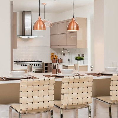 Inspiration for a contemporary u-shaped eat-in kitchen remodel in Dublin with flat-panel cabinets, brown cabinets, white backsplash, subway tile backsplash, stainless steel appliances and an island