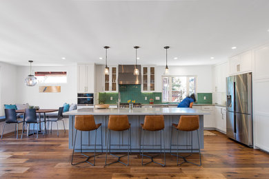 Mid-sized trendy l-shaped medium tone wood floor and brown floor eat-in kitchen photo in San Diego with an undermount sink, shaker cabinets, white cabinets, marble countertops, green backsplash, ceramic backsplash, stainless steel appliances, an island and gray countertops