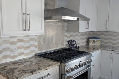 Example of a large transitional porcelain tile and beige floor eat-in kitchen design in New York with an undermount sink, beaded inset cabinets, white cabinets, granite countertops, white backsplash, marble backsplash, stainless steel appliances, an island and beige countertops