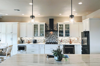 サクラメントにある高級な広いトランジショナルスタイルのおしゃれなキッチン (シェーカースタイル扉のキャビネット、白いキャビネット、珪岩カウンター、マルチカラーのキッチンパネル、ガラスタイルのキッチンパネル、シルバーの調理設備、クッションフロア、茶色い床、白いキッチンカウンター、アンダーカウンターシンク) の写真