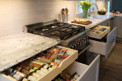 Large transitional medium tone wood floor eat-in kitchen photo in Seattle with an undermount sink, shaker cabinets, gray cabinets, quartz countertops, white backsplash, porcelain backsplash, stainless steel appliances and an island