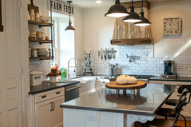 Inspiration for a mid-sized country u-shaped medium tone wood floor and brown floor eat-in kitchen remodel in Philadelphia with a farmhouse sink, shaker cabinets, white cabinets, white backsplash, subway tile backsplash, stainless steel appliances and an island