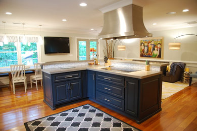 Example of a mid-sized trendy u-shaped medium tone wood floor and brown floor open concept kitchen design in Atlanta with raised-panel cabinets, dark wood cabinets, zinc countertops, white backsplash, ceramic backsplash, stainless steel appliances, an island and an undermount sink