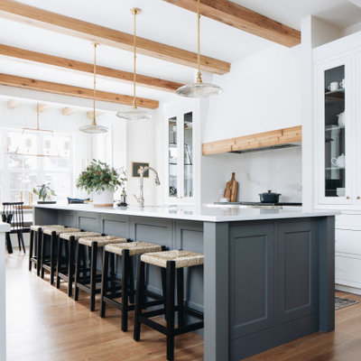 Eat-in kitchen - country galley medium tone wood floor, brown floor and exposed beam eat-in kitchen idea in Chicago with shaker cabinets, white cabinets, white backsplash, an island and white countertops