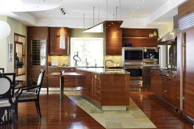 Example of a large zen l-shaped medium tone wood floor and brown floor open concept kitchen design in Toronto with an undermount sink, flat-panel cabinets, medium tone wood cabinets, granite countertops, metallic backsplash, metal backsplash, stainless steel appliances, an island and brown countertops