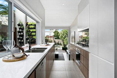 Inspiration for a contemporary galley kitchen pantry in Sydney with a double-bowl sink, white cabinets, ceramic flooring, no island and beige floors.