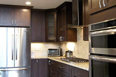 Large transitional l-shaped dark wood floor and brown floor open concept kitchen photo in San Francisco with an undermount sink, recessed-panel cabinets, dark wood cabinets, granite countertops, beige backsplash, ceramic backsplash, stainless steel appliances, an island and gray countertops
