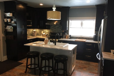 Mid-sized trendy u-shaped porcelain tile enclosed kitchen photo in New York with a farmhouse sink, shaker cabinets, black cabinets, quartz countertops, multicolored backsplash, mosaic tile backsplash, stainless steel appliances and an island