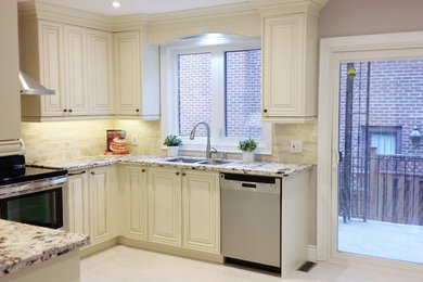 Mid-sized elegant u-shaped ceramic tile and beige floor enclosed kitchen photo in Toronto with a double-bowl sink, raised-panel cabinets, white cabinets, granite countertops, beige backsplash, stone tile backsplash, stainless steel appliances and a peninsula
