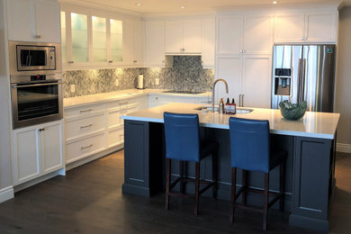 Example of a large transitional l-shaped open concept kitchen design in Toronto with an island
