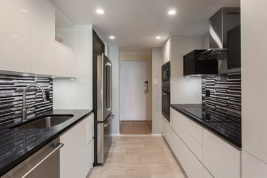 Small trendy galley porcelain tile kitchen photo in Philadelphia with an undermount sink, flat-panel cabinets, white cabinets, quartzite countertops, metal backsplash and stainless steel appliances