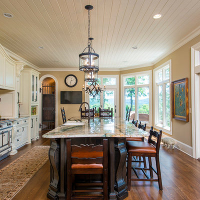 Inspiration for a timeless galley eat-in kitchen remodel in Other with raised-panel cabinets and beige cabinets