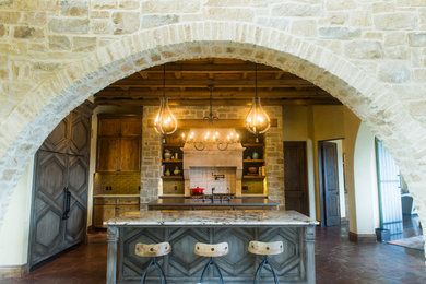 Photo of a large eclectic kitchen in Austin with a submerged sink, medium wood cabinets, engineered stone countertops, grey splashback, stainless steel appliances and terracotta flooring.